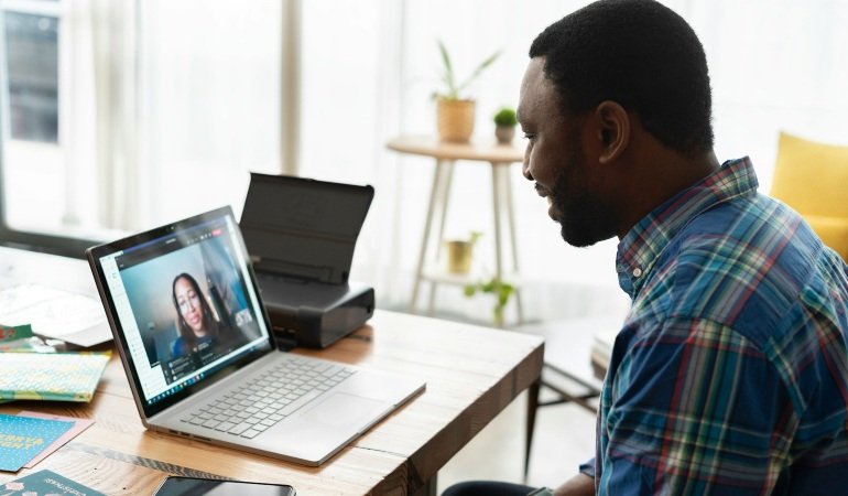 Man in a shirt during a video call.